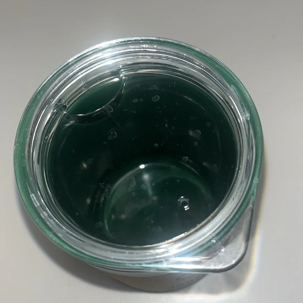 Jagermeister cork, plastic cup cooler with lid small green in color